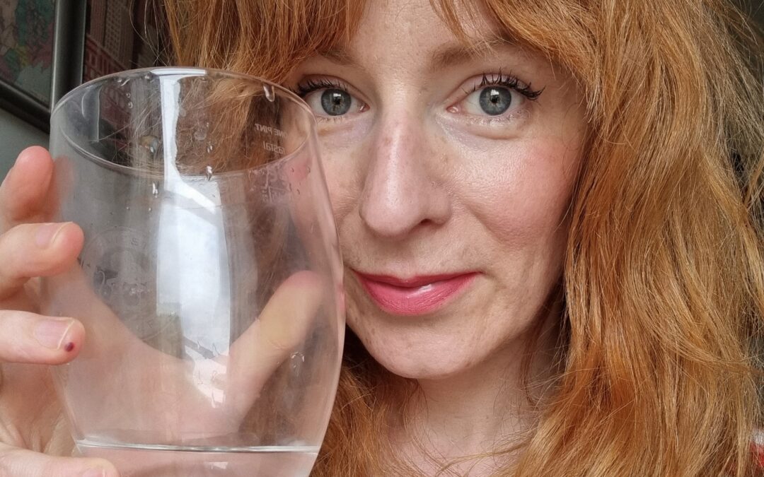 Wilma close up holding a glass of water